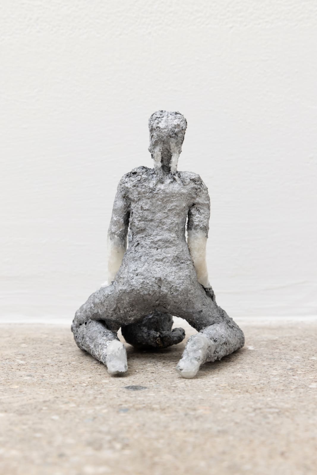 Free-standing sculpture made from lost-wax cast aluminum featuring a kneeling human figure behind a dog. 