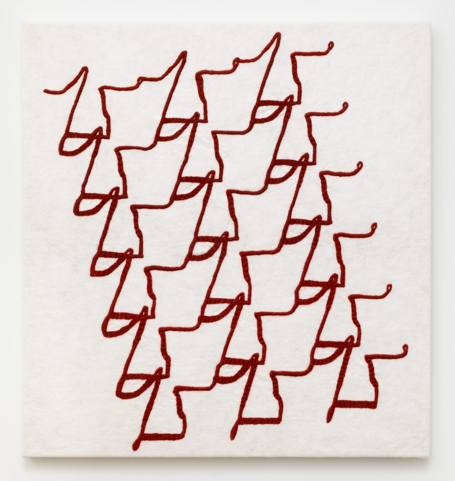 Wall-mounted panel with red wool embroidered abstract pattern on a white wool felt base.