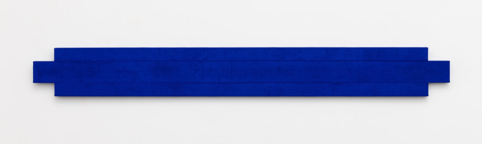 Horizontal shaped canvas painting stretched on three wooden bars, monochromatic in Yves Klein blue. 