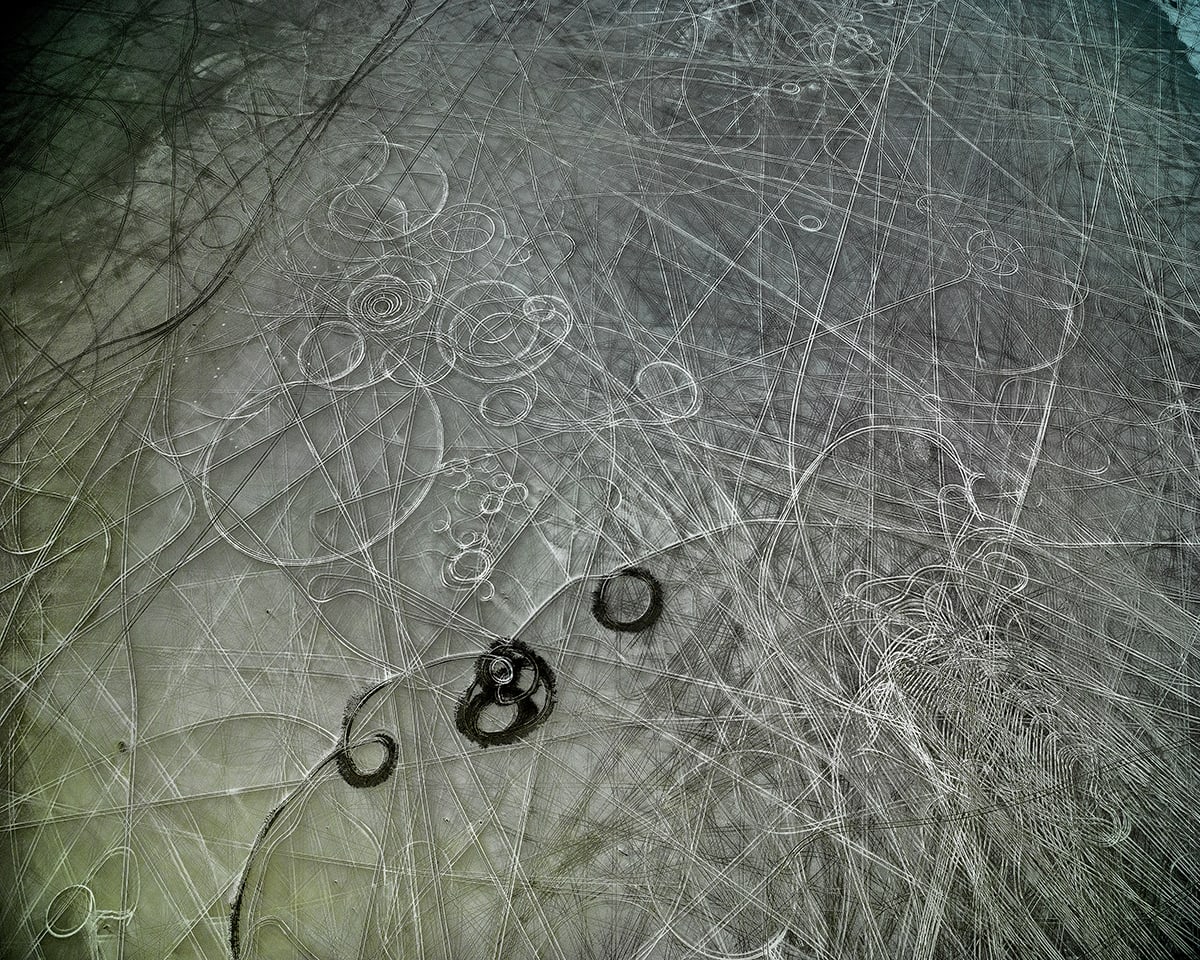 Lines and squiggle carved into dark ice.