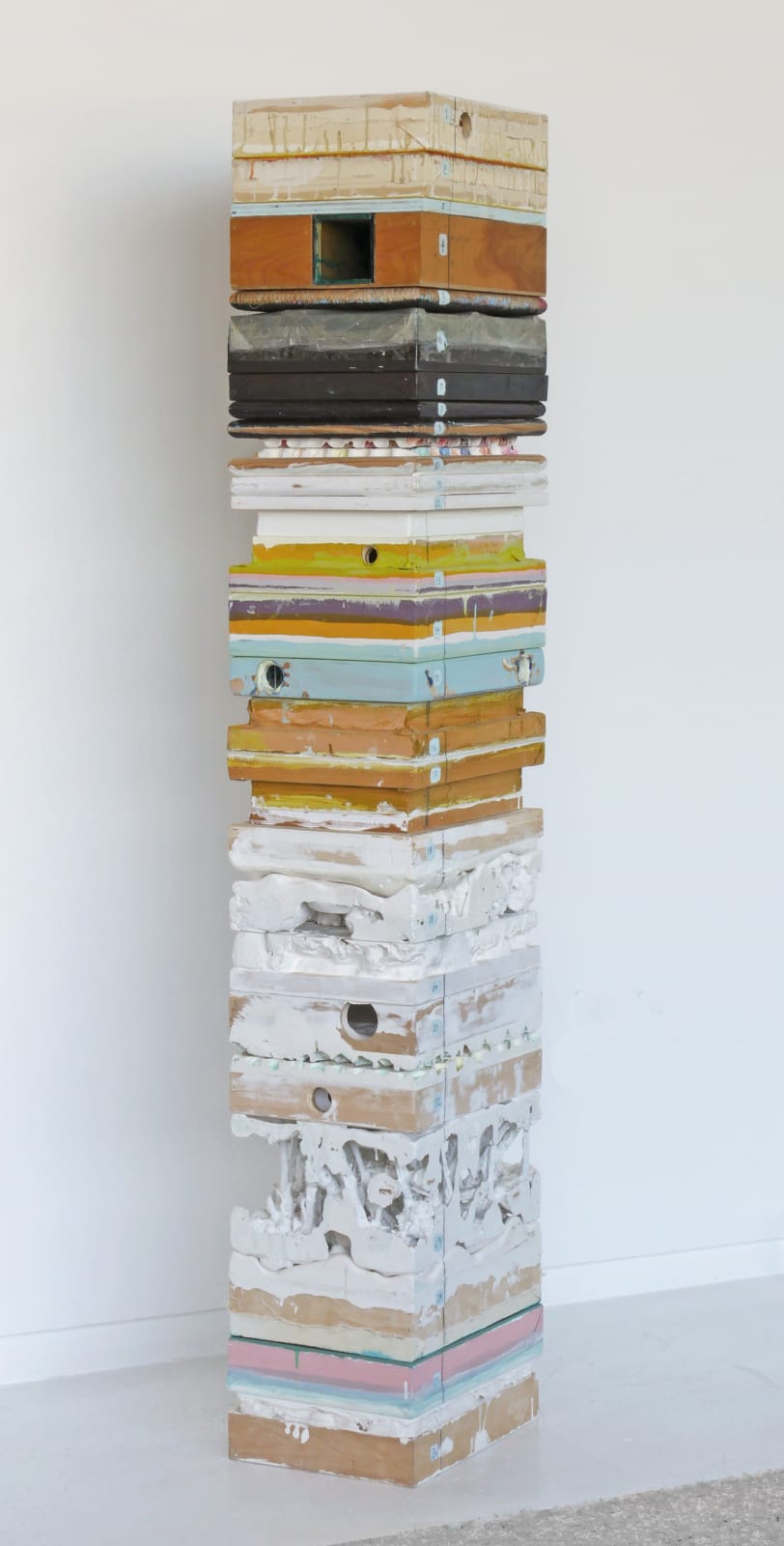 tacked mixed media blocks which fit together showing their textured and multi-colored sides Each layer can be removed and stand alone to reveal the intricacies of their surfaces