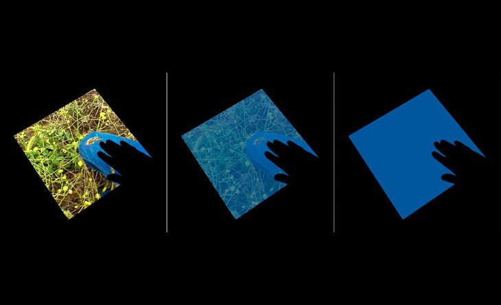 Three still images side by side capture the different stages of the piece At left an image of green grass and a blue plastic toy are displayed on a touch screen. In the lower right corner of the left image a darkened hand touches the blue portion of the screen. The middle and left images show the same screen gradually turning blue due to the hand touching that portion of the original image on the screen