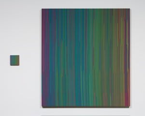 Two dark, striped painted panels follow the same rainbow pattern The panel to the right is a large rendition of the color pattern while the one on the left is much smaller