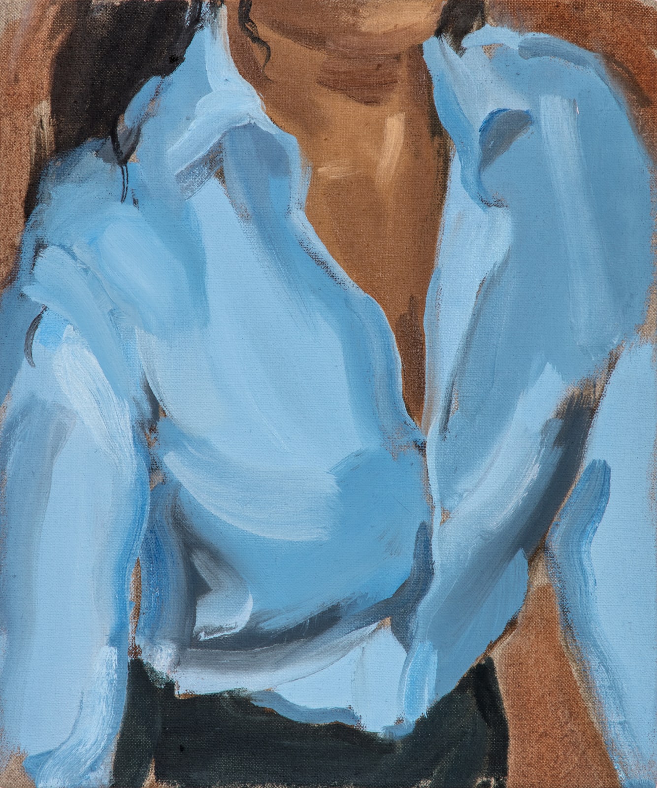 Woman wearing light blue shirt partially unbuttoned is leaning forward. Woman’s head and lower body are cropped out of the composition.