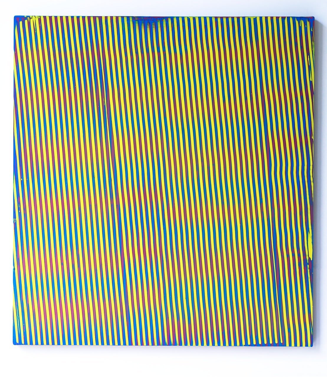 Yellow green and blue paint layered to create a slanted moiré effect