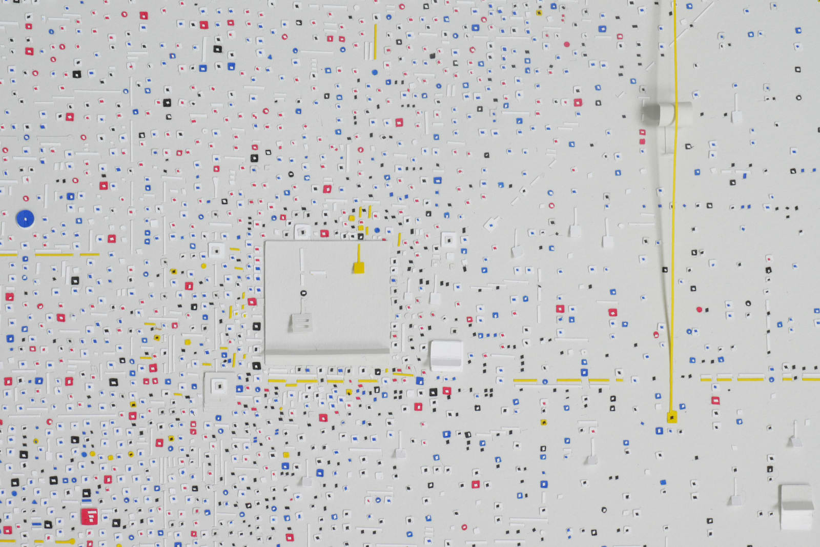 Detail; thousands of white, blue, red, and yellow 1D and 3D cutouts on a white background.