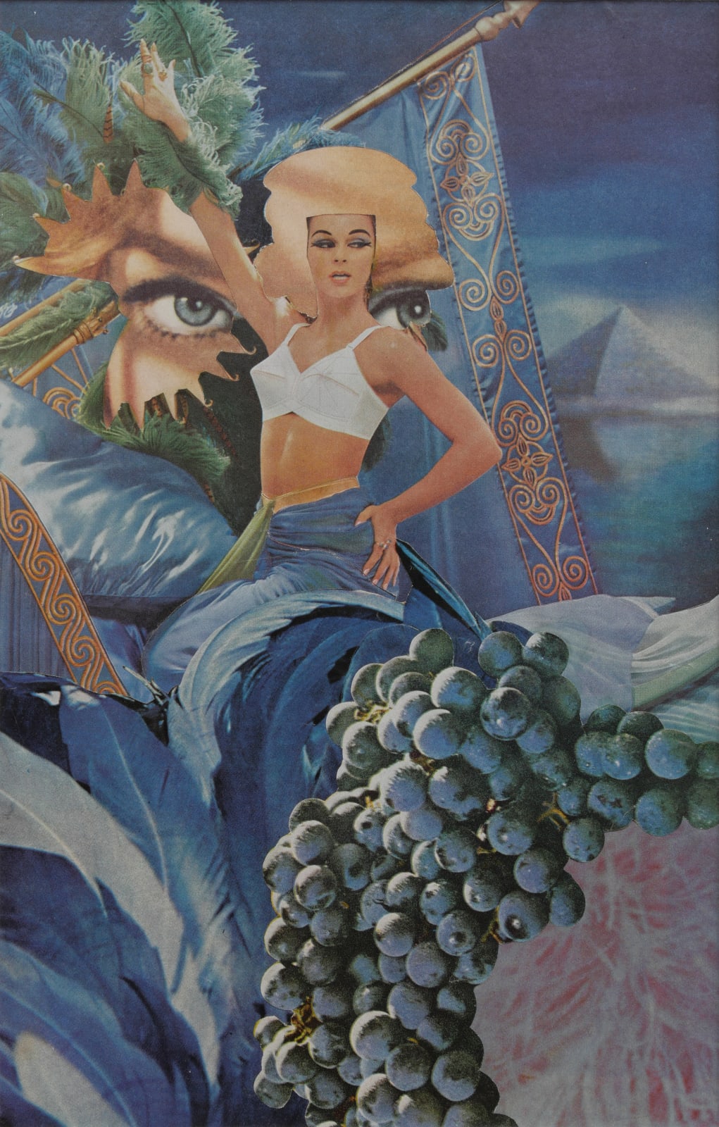 Paper collage of various cut outs from nineteen seventies magazines create the image of a topless white woman sitting amongst large blue feathers pillows flags and grapes in the background large blue eyes can be seen from behind the woman and a blue pyramid is blurred in the upper right