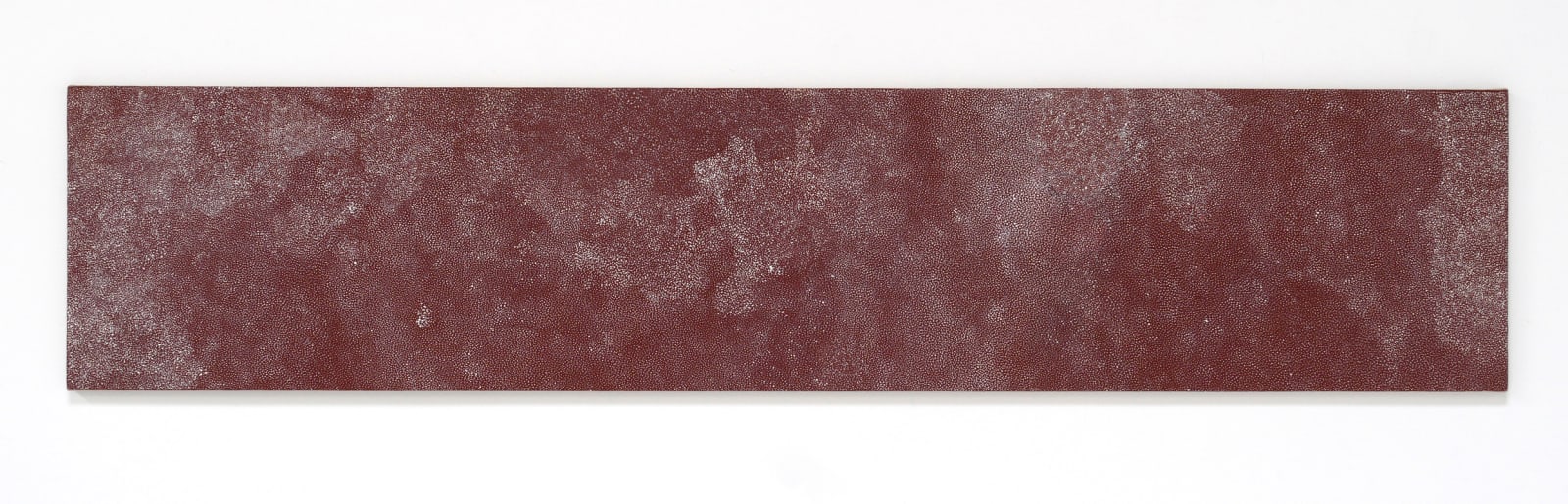 Clouds of non-uniform white dots create an abstract pattern against a maroon background.
