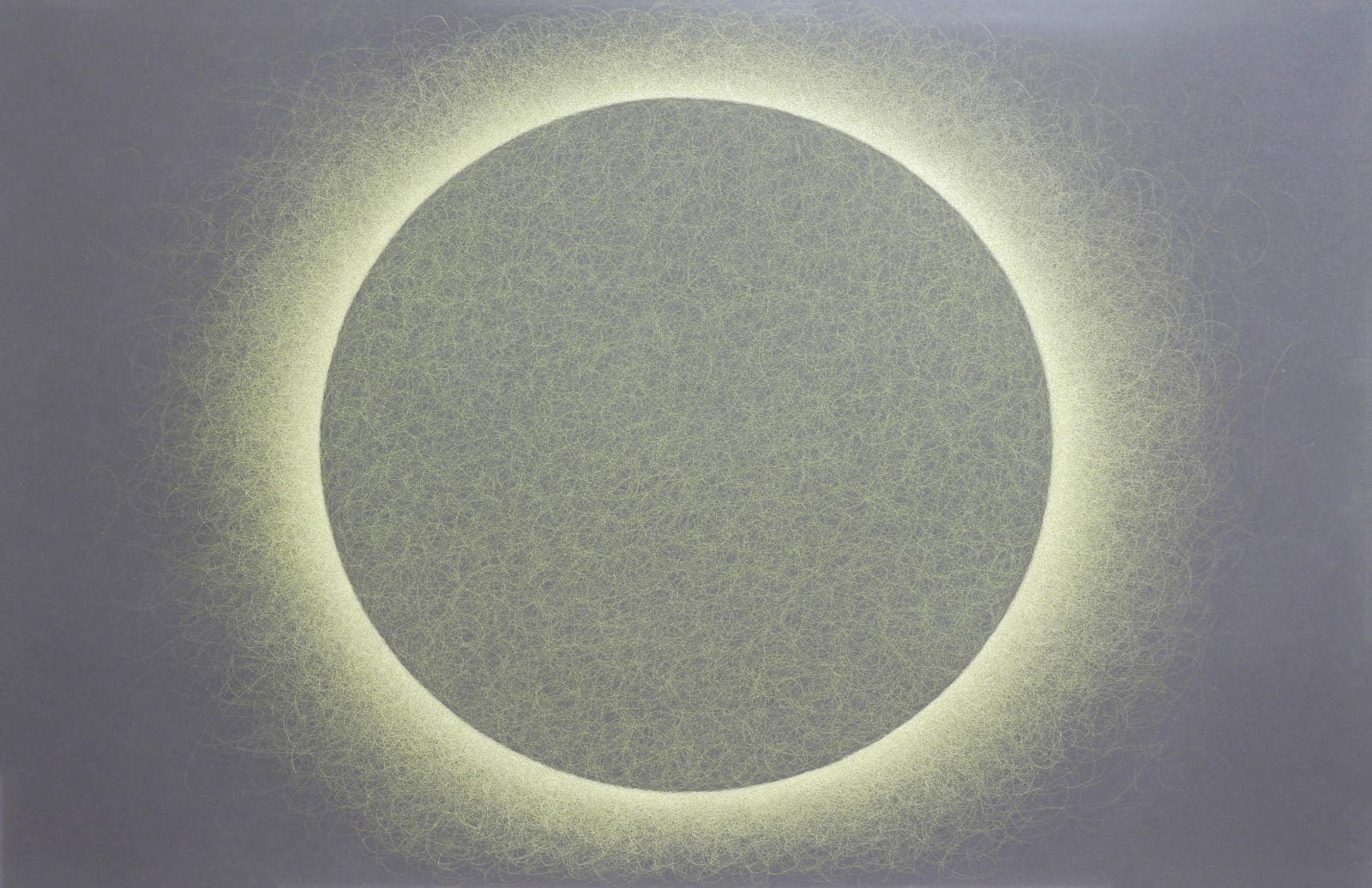 A greenish sphere is backlit by a neon yellow halo on a black horizontal rectangular background.