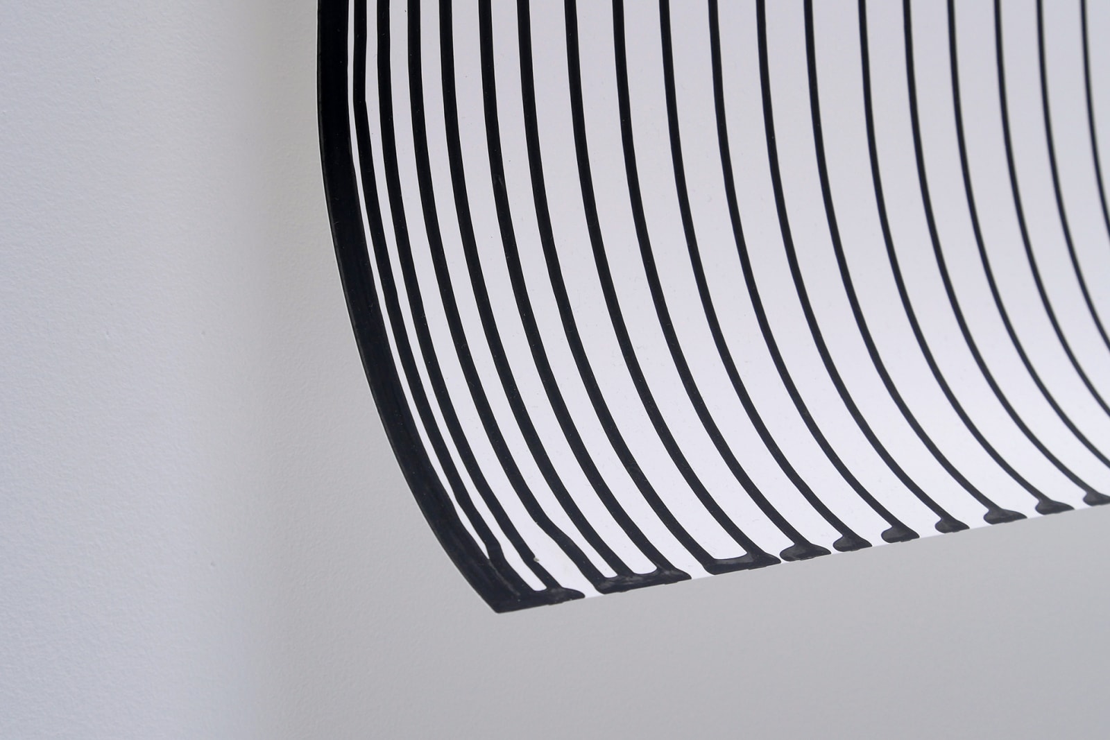 Close up of the end of the paper with multiple lines of ink from the artist's India ink pieces