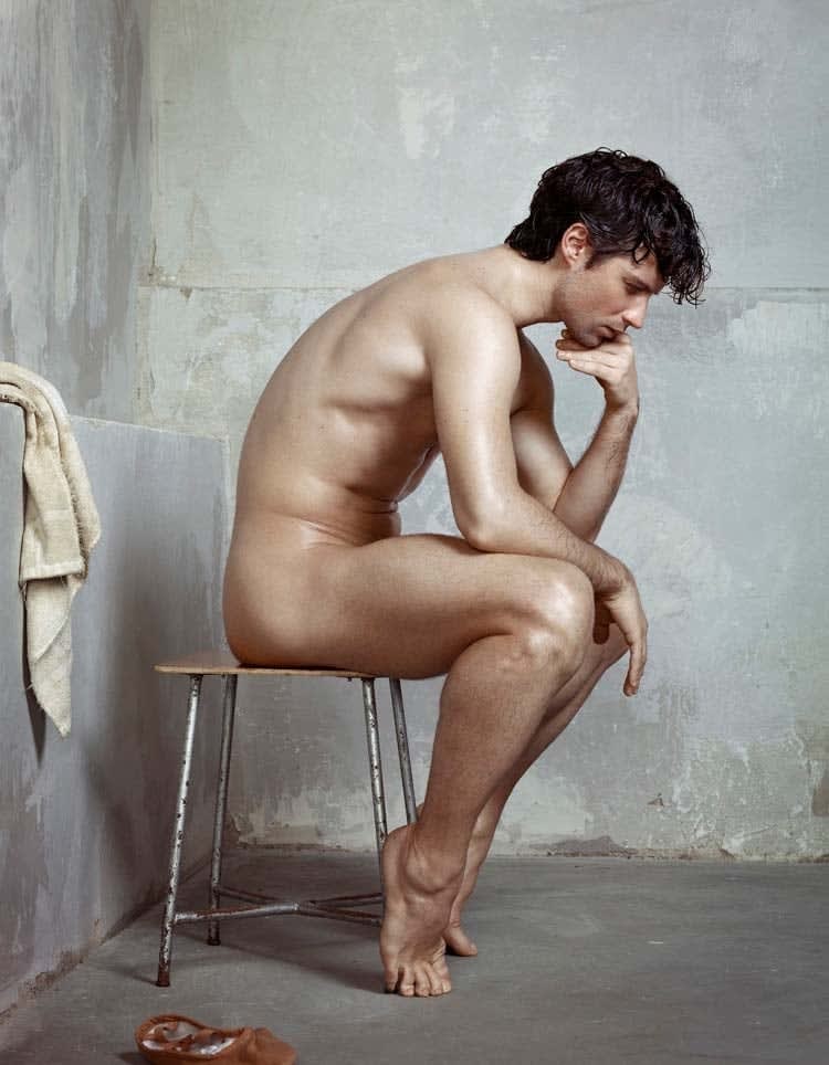 Nude male ballet dancer sitting in pose reminiscent of The Thinker sculpture by Rodin, photograph by Erwin Olaf