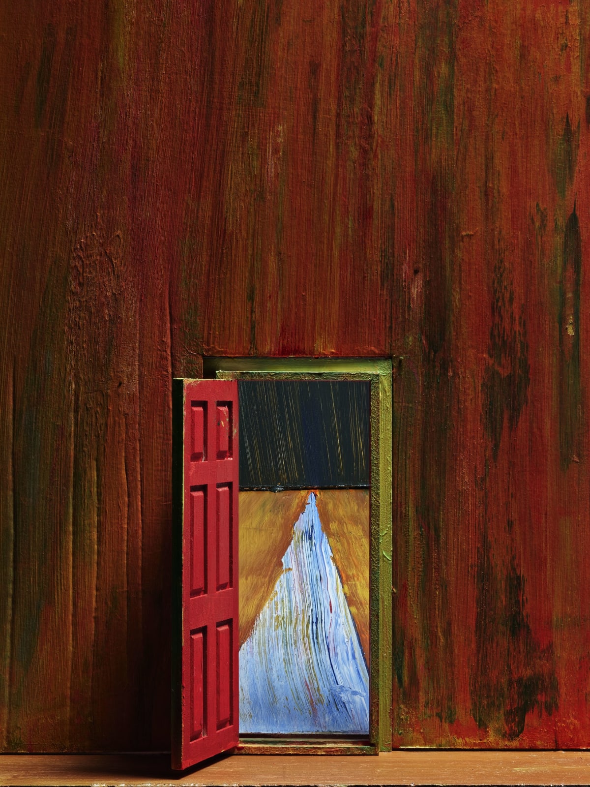 red door open in red painted room