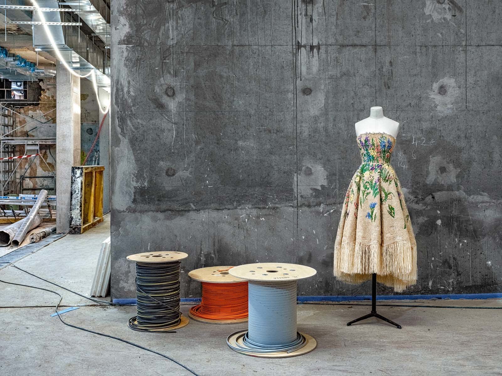 Maria Grazia Chiuri design strapless dress on bust next to spools of electric cable at Dior flagship at 30 Montaigne Ave in Paris by Robert Polidori
