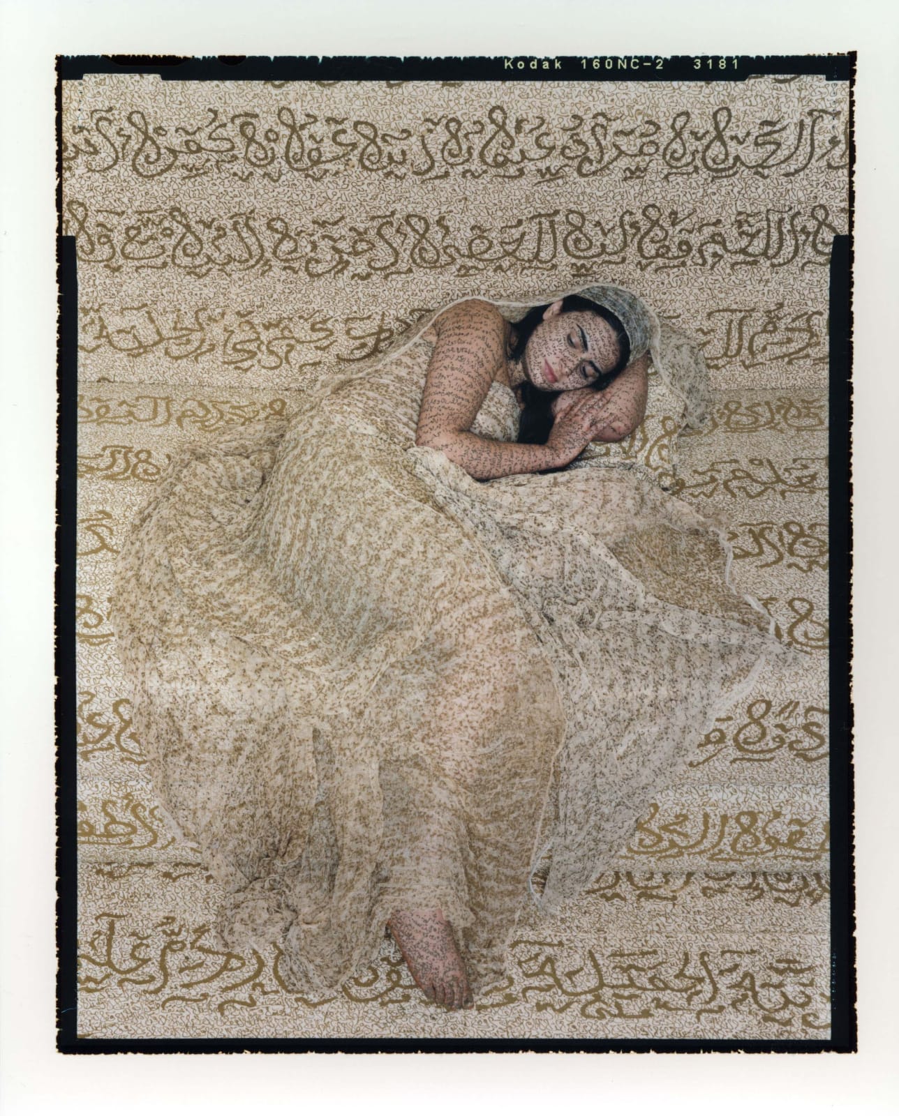 Woman reclining with henna calligraphy inscribed on clothing fabric and skin, from the Les Femmes du Maroc series, by Lalla Essaydi