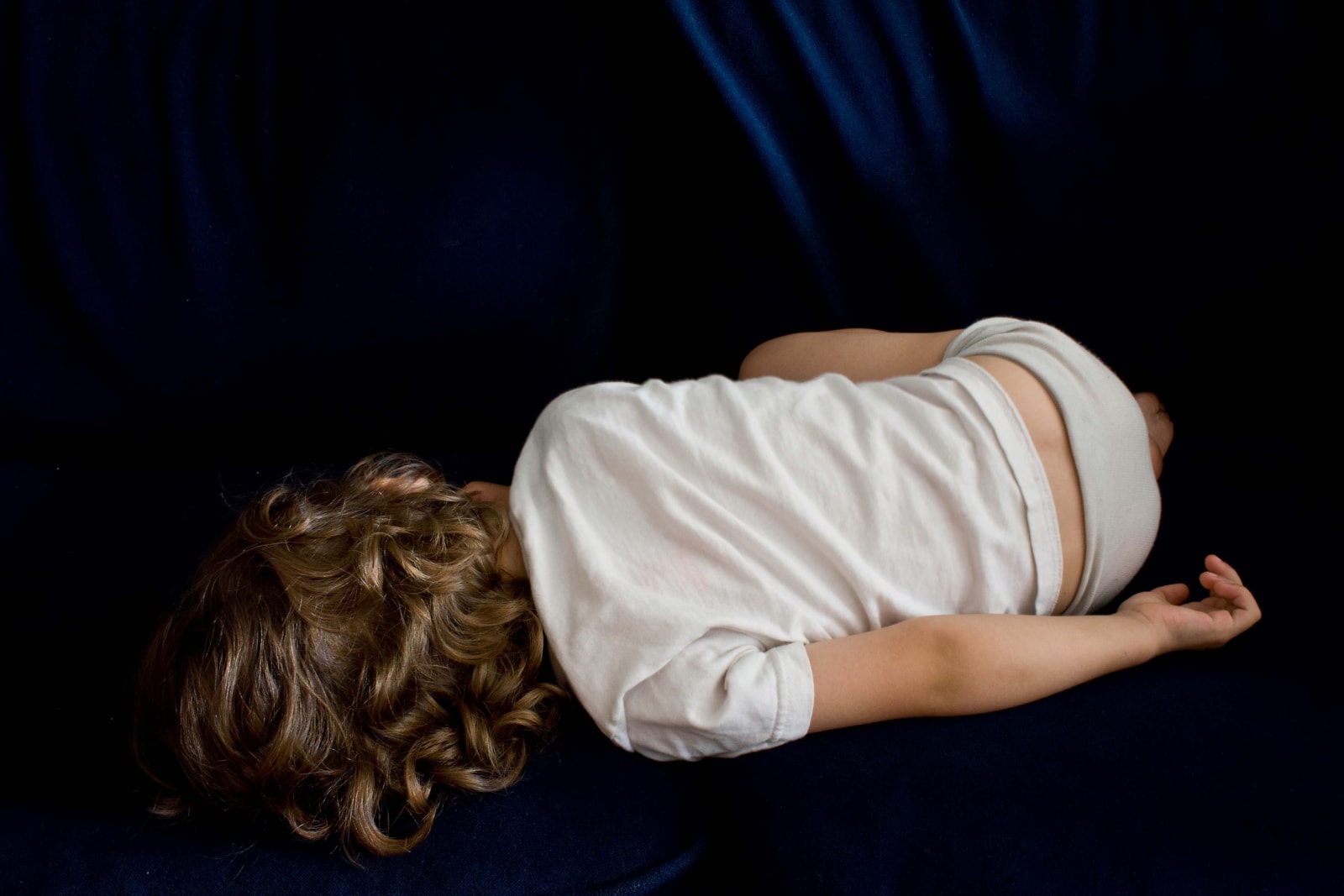 Elinor Carucci photograph of the artist's son laying on the couch