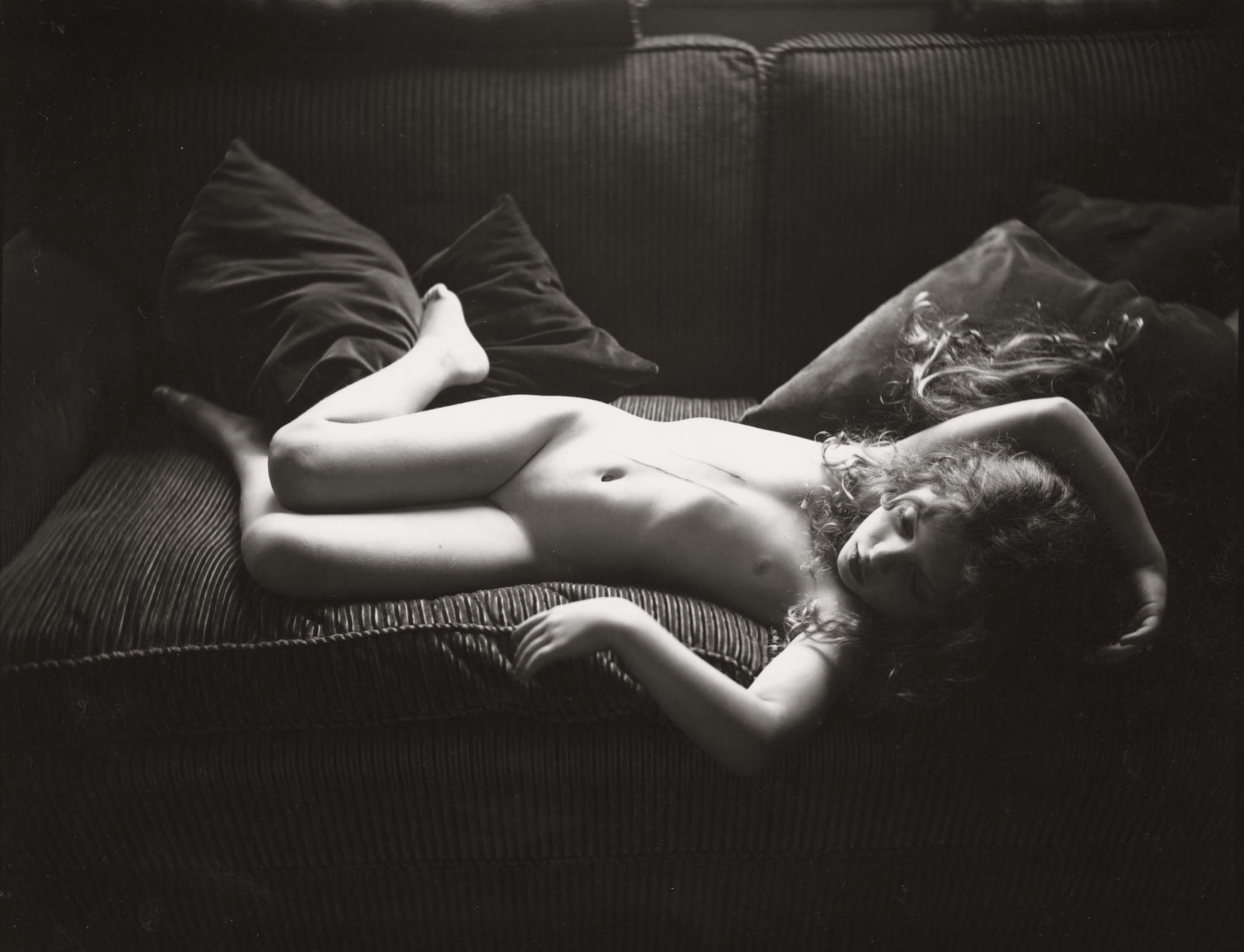 adolescent girl reclining nude on couch with dog scratches on her abdomen, by Sally Mann