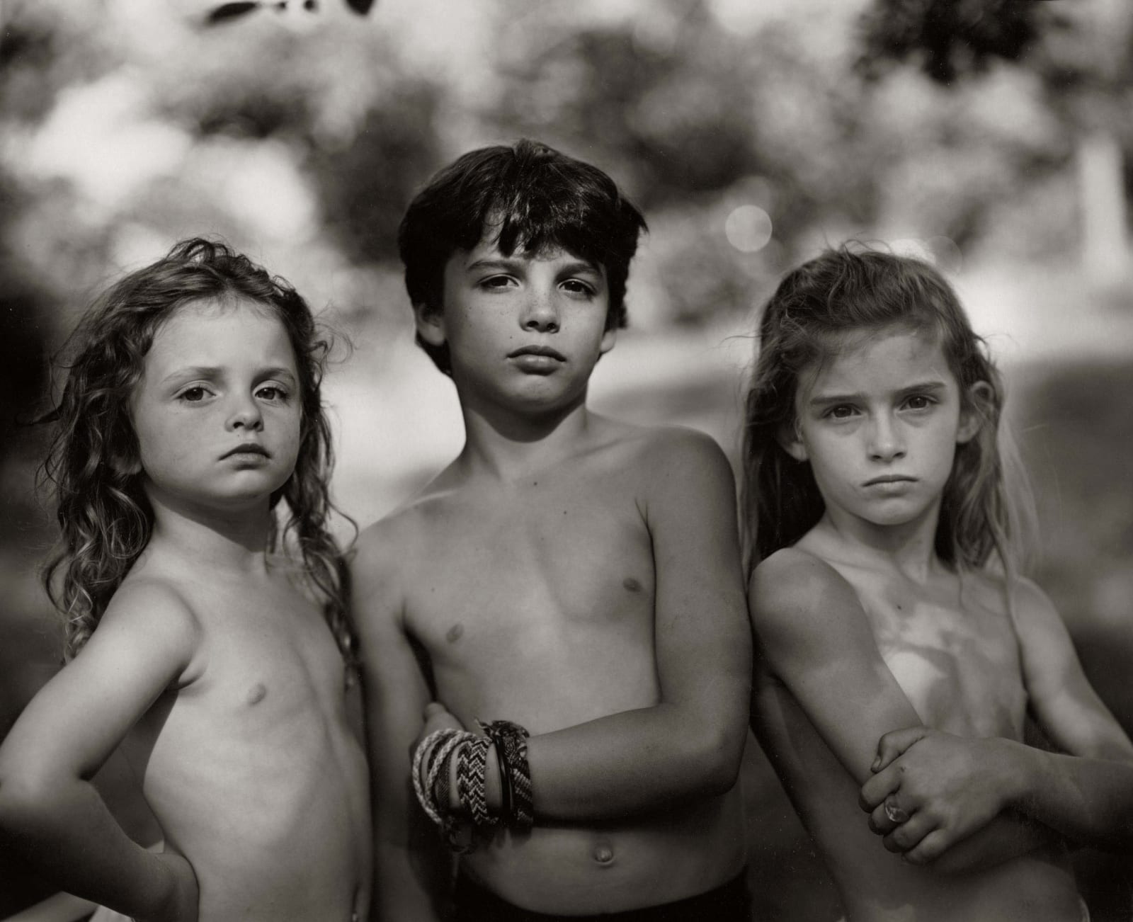 Emmett, Jessie and Virginia posing outdoors, from the Immediate Family series, by Sally Mann