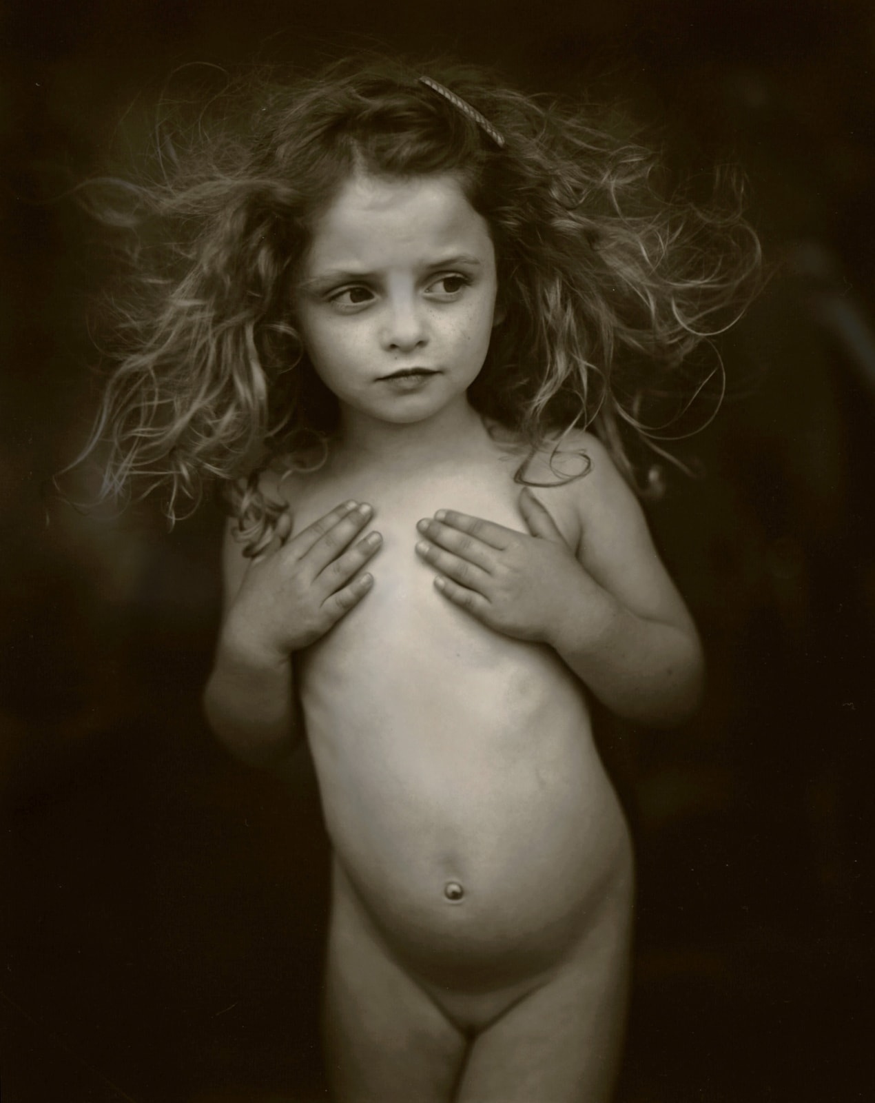 Sally Mann Immediate Family series, Modest Child, photograph of Virginia holding her hands over her chest