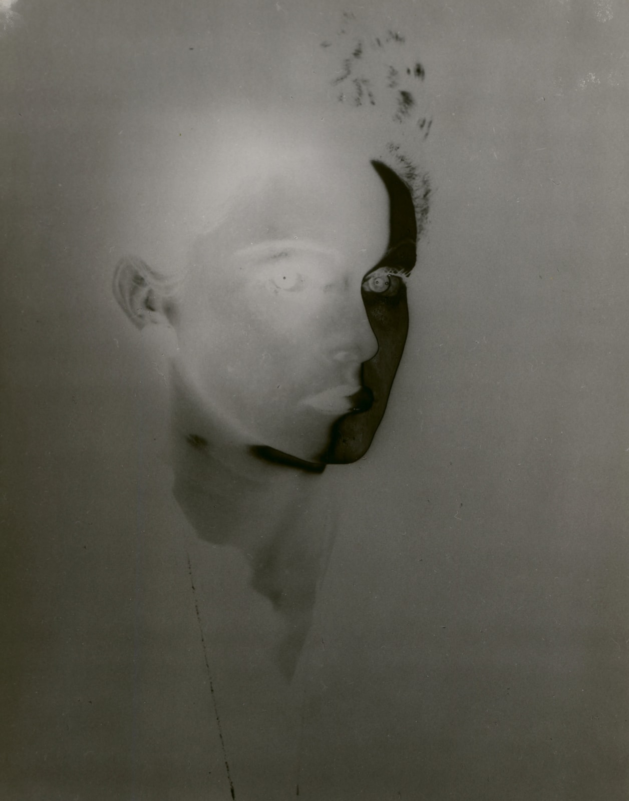 Erwin Blumenfeld experimental solarized portrait of woman's face in three quarter view