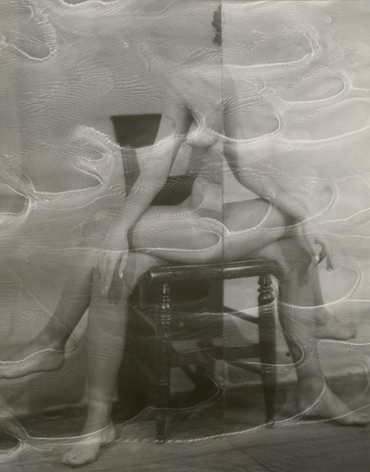Erwin Blumenfeld mirror image of half of woman sitting on chair