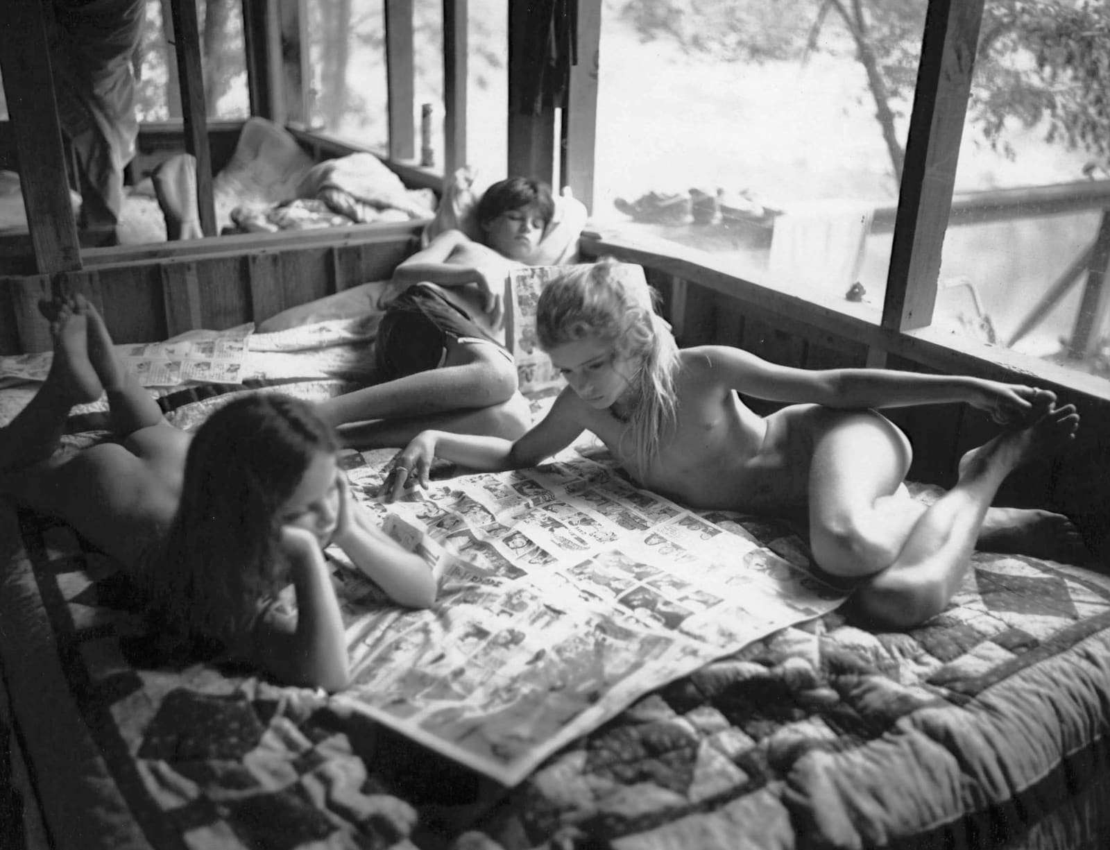 Emmett, Jessie and Virginia reading the Sunday funnies, from the Immediate Family series by Sally Mann