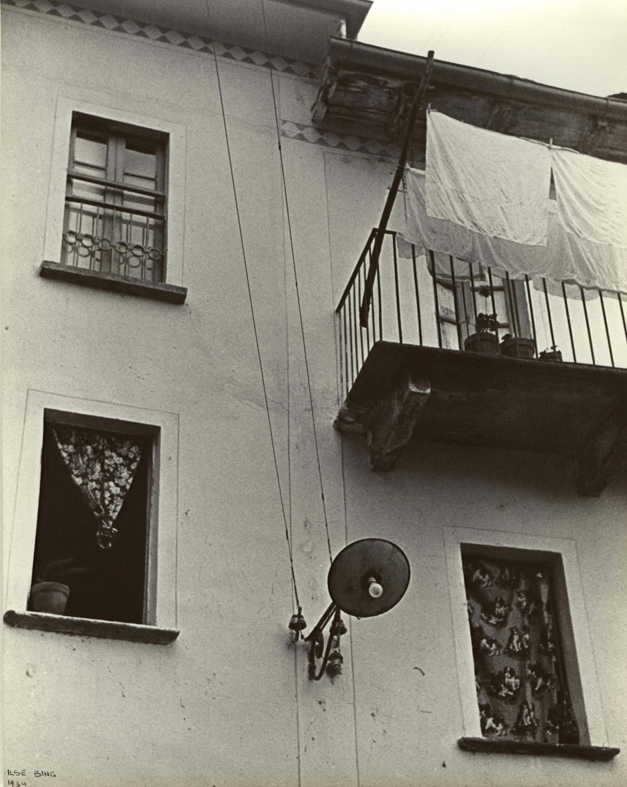 Ilse Bing photograph of windows and balcony with laundry in Switzerland