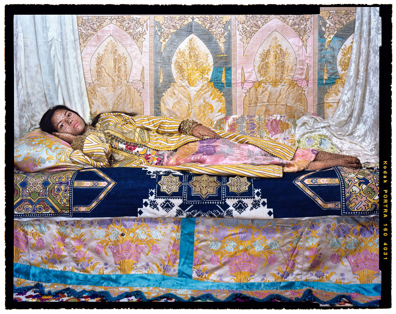 Lalla Essaydi, Harem Revisited #33, 2012, Reclining woman in brightly colored Moroccan silk fabric
