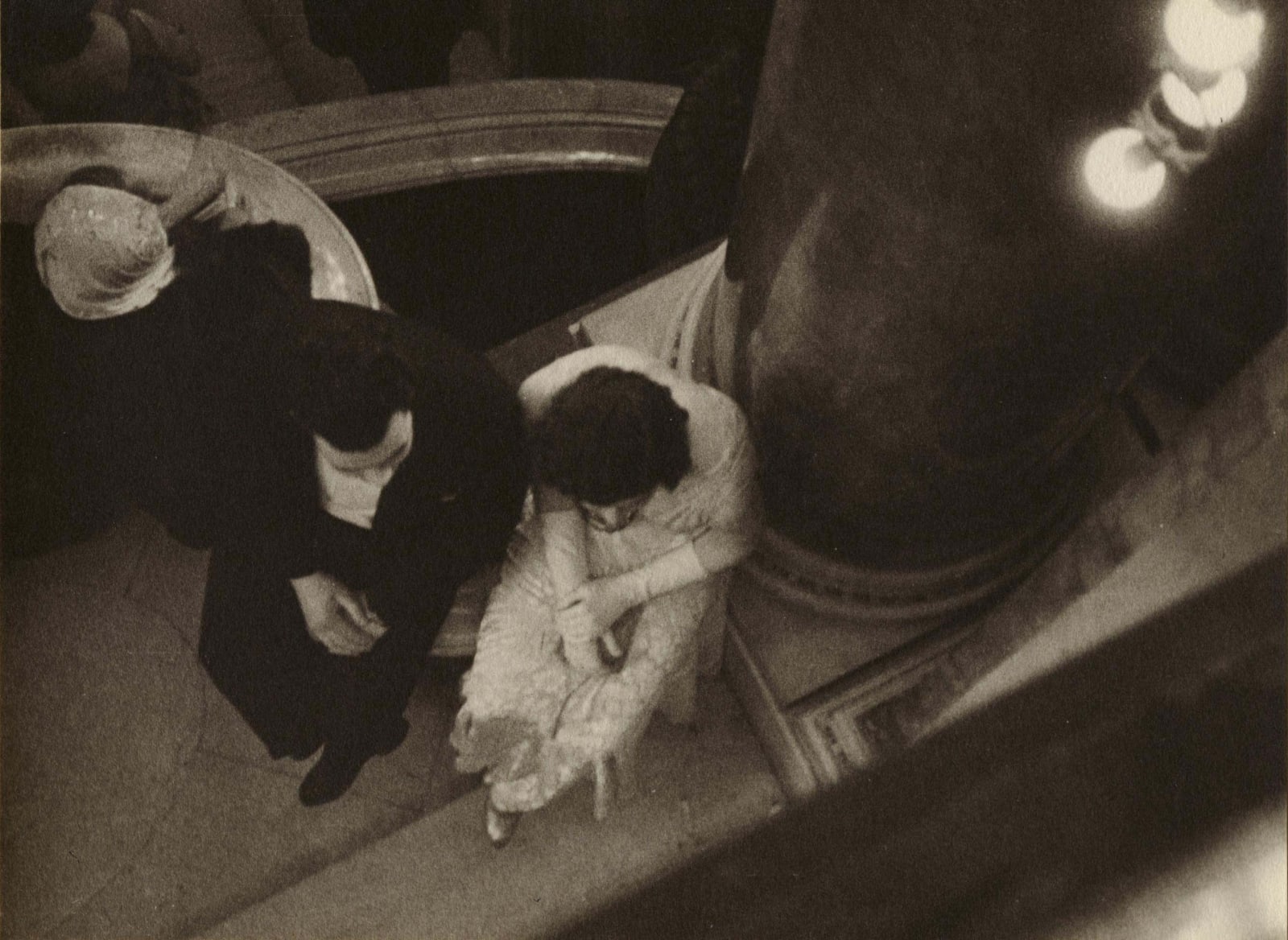 Ilse Bing photograph looking down on man and woman in black tie sitting down