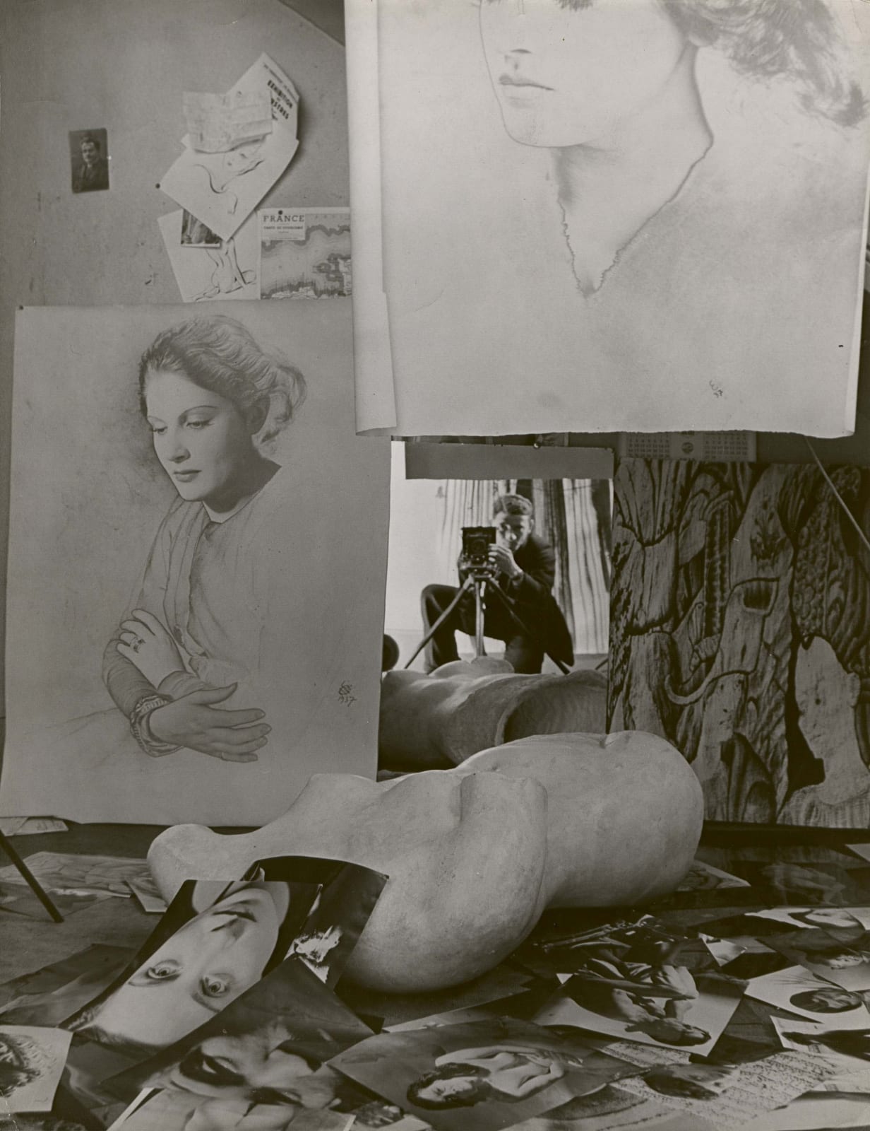Erwin Blumenfeld self portrait in mirror with portraits of woman in studio