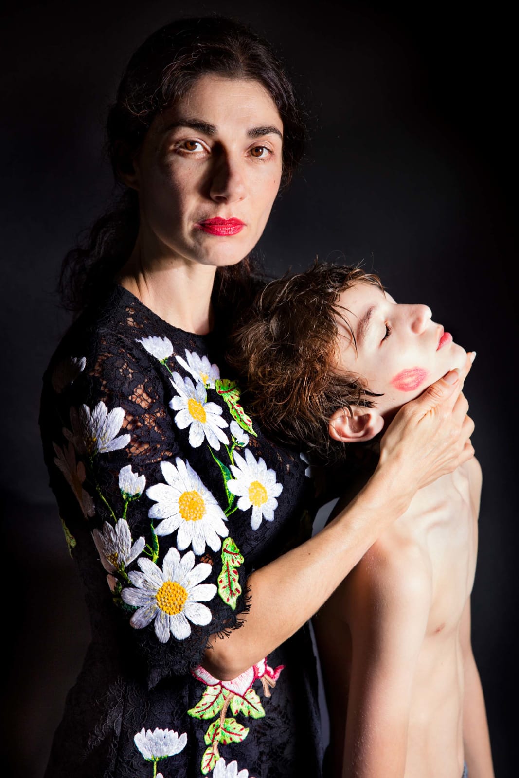 Elinor Carucci photograph of the artist in a dress with daisies with her son