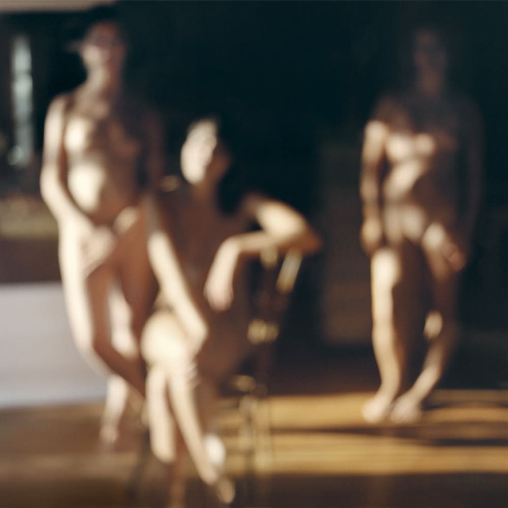 Three blurry figures in Renoir ballet-style soft focus composition, by Mona Kuhn