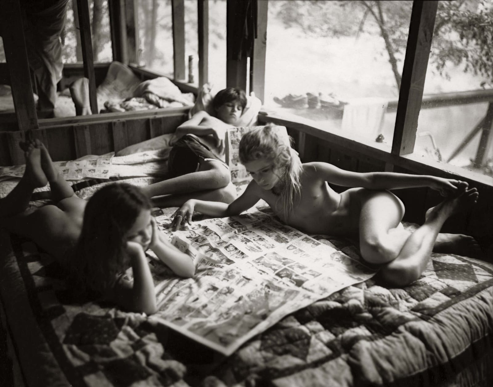 Emmett, Jessie and Virginia reading the Sunday funnies, from the Immediate Family series by Sally Mann