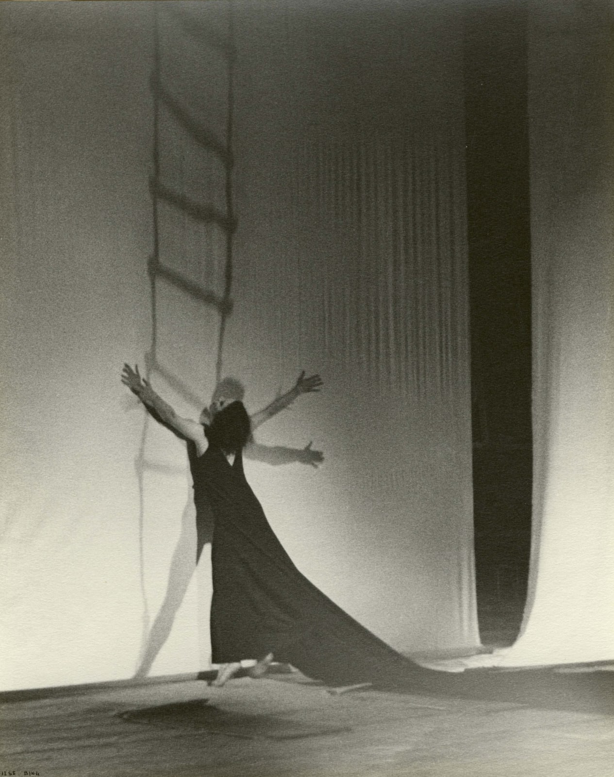 Ilse Bing photograph of woman on stage and man behind transparent sheet, embracing