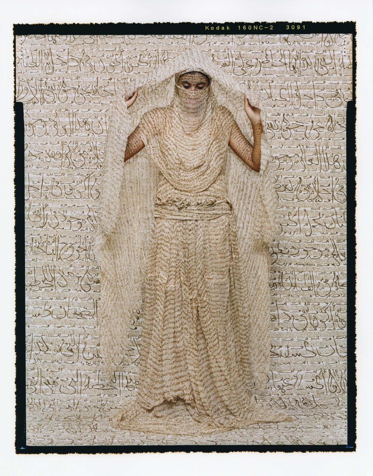 Lalla Essaydi Les Femmes du Maroc, woman lifting fabric from her body, her skin and all fabric inscribed with Arabic calligraphy in henna