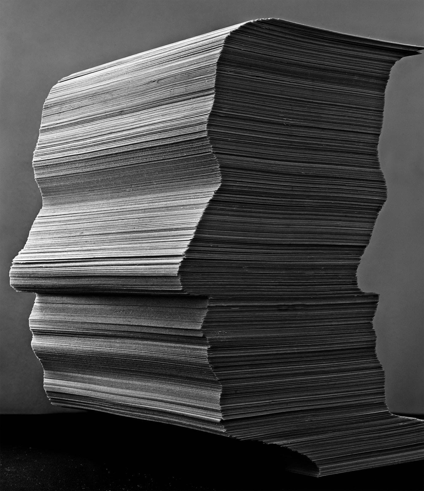 Abelardo Morell Paper Son black and white photograph of stack of papers in shape of the silhouette of artist's son Brady