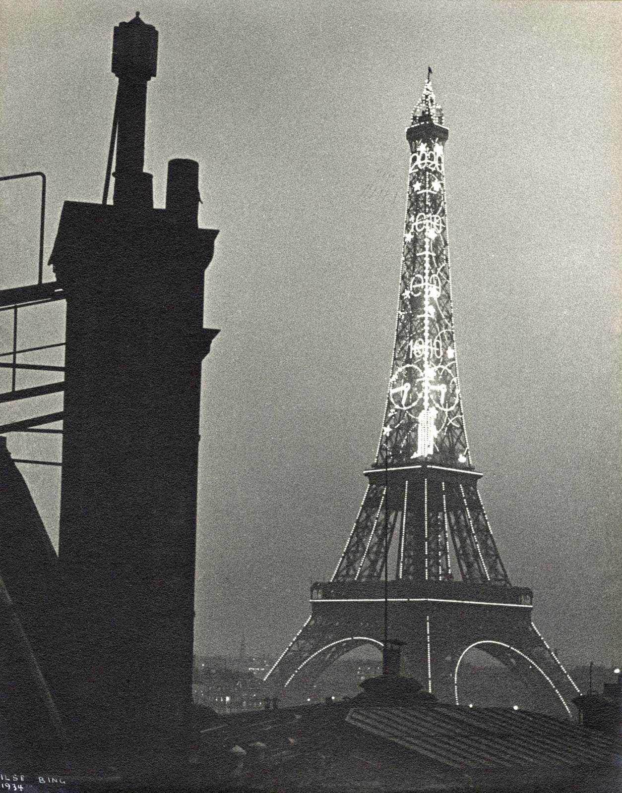Ilse Bing photograph of Eiffel Tower illuminated at night in Paris