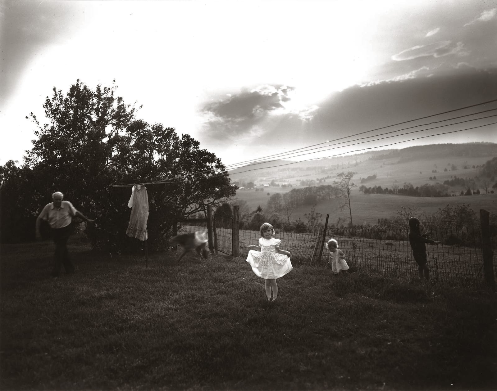 Jessie in white Easter dress outside, from the Immediate Family series by Sally Mann