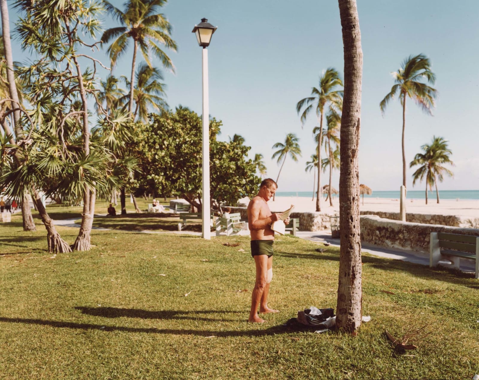 Man in bathing suit reading in Miami Beach, Florida by Stephen Shore