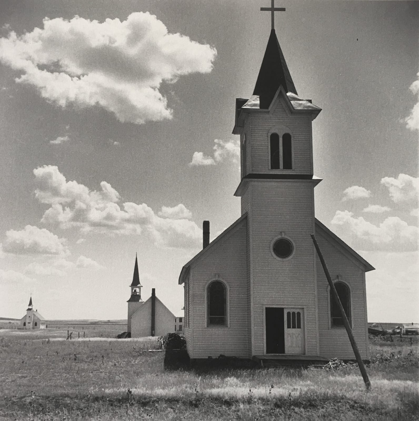 Dorothea Lange On the Great Plains near Winner South Dakota three churches with clouds in sky