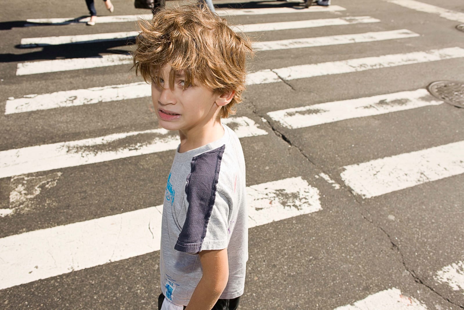 Elinor Carucci photograph of the artist's son about to cross the street