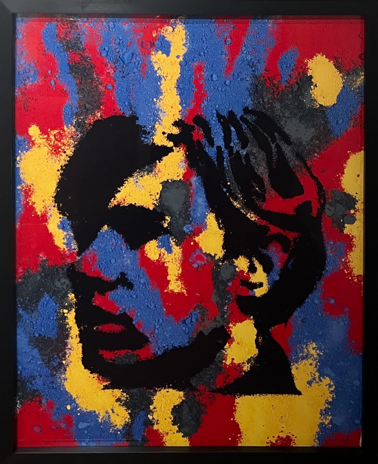 Screen print portrait of Andy Warhol made out of red, yellow, blue and black paint pigment by Vik Muniz