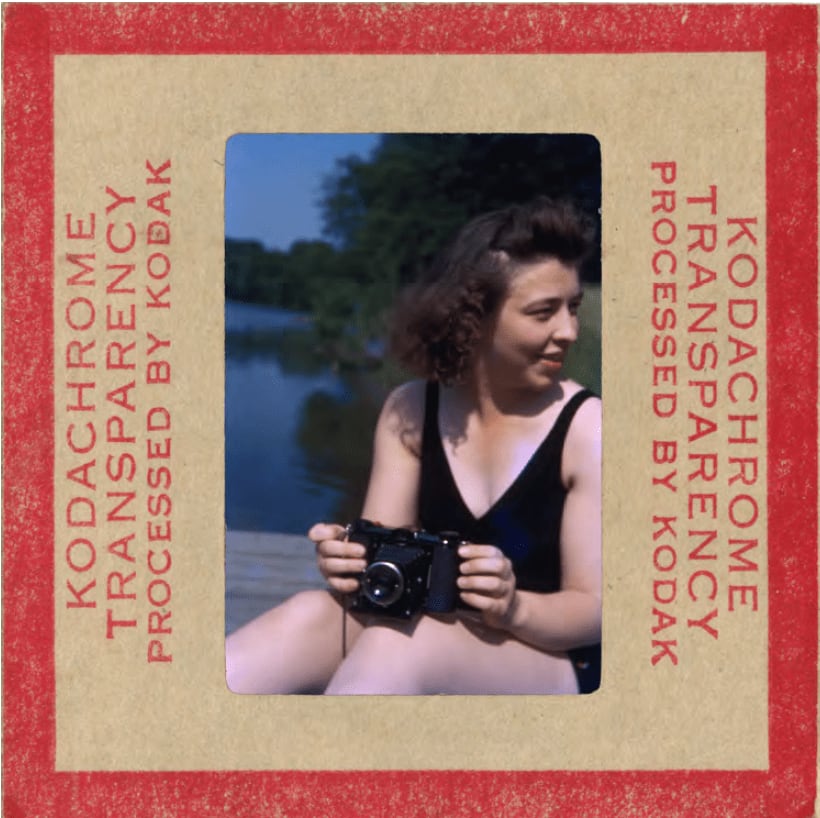 Vintage slide of woman holding camera in hand at lake by Lee Shulman and The Anonymous Project