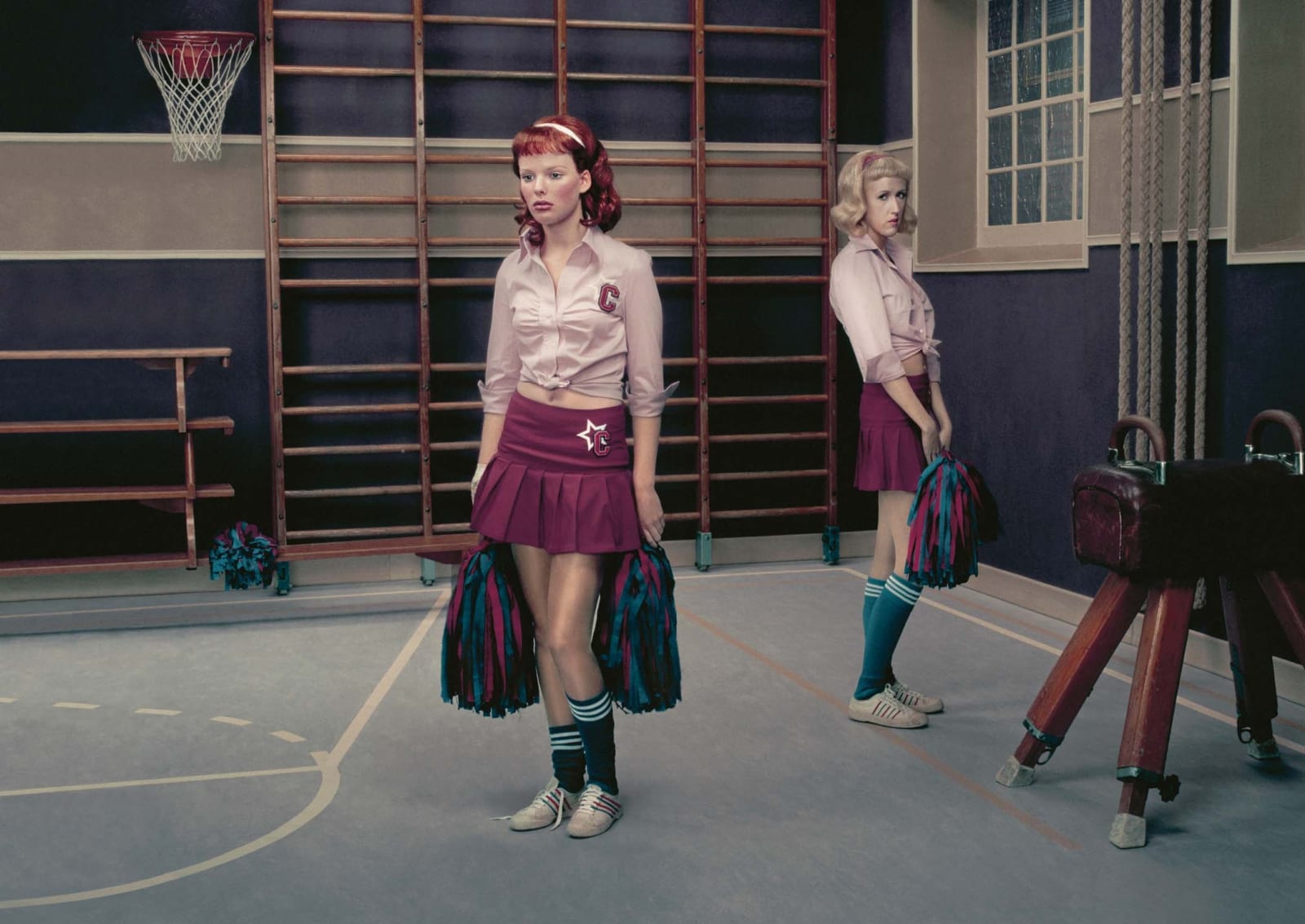 Two cheerleaders in gym by Erwin Olaf