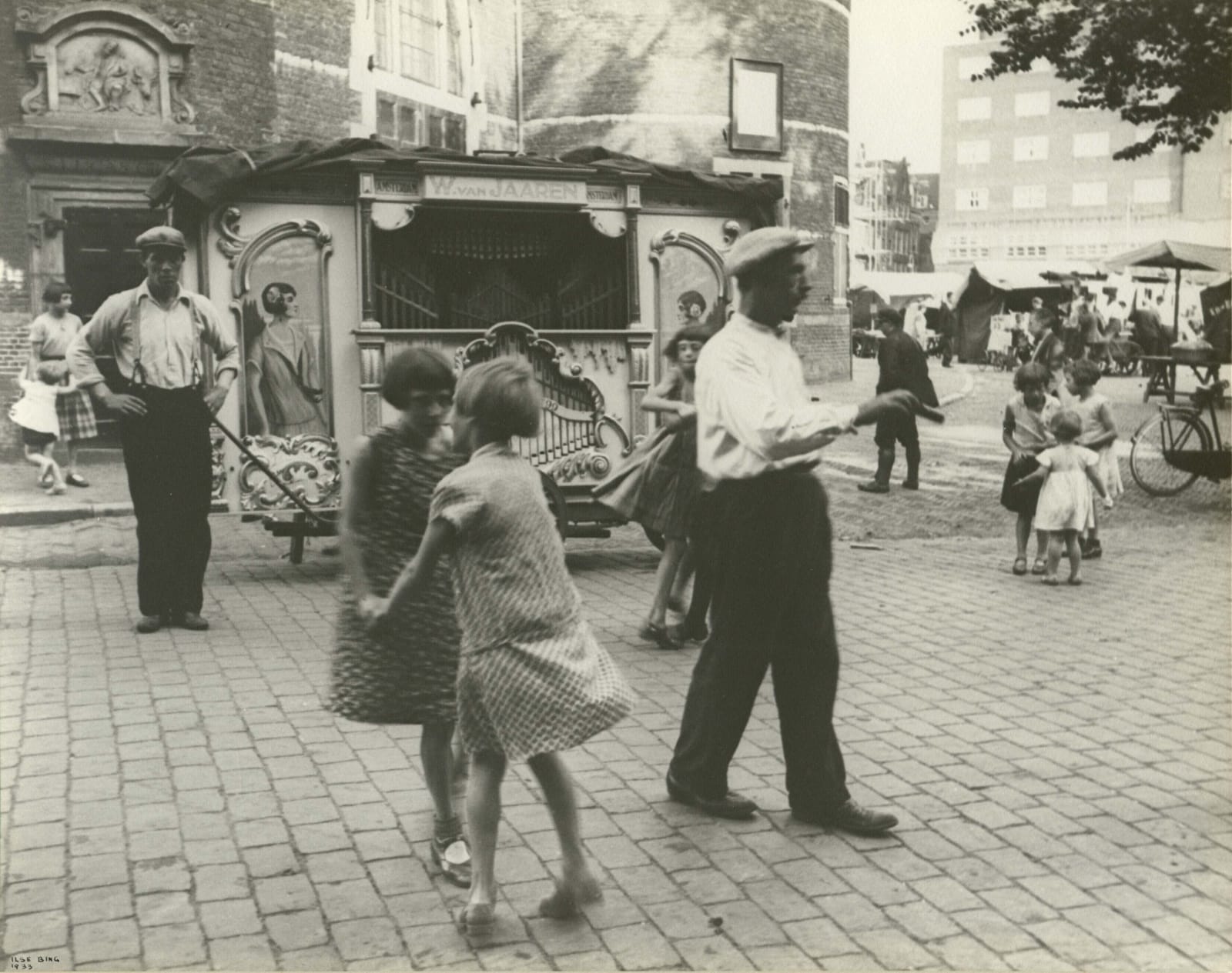 Ilse Bing photograph of girls dancing outside street organ in Amsterdam