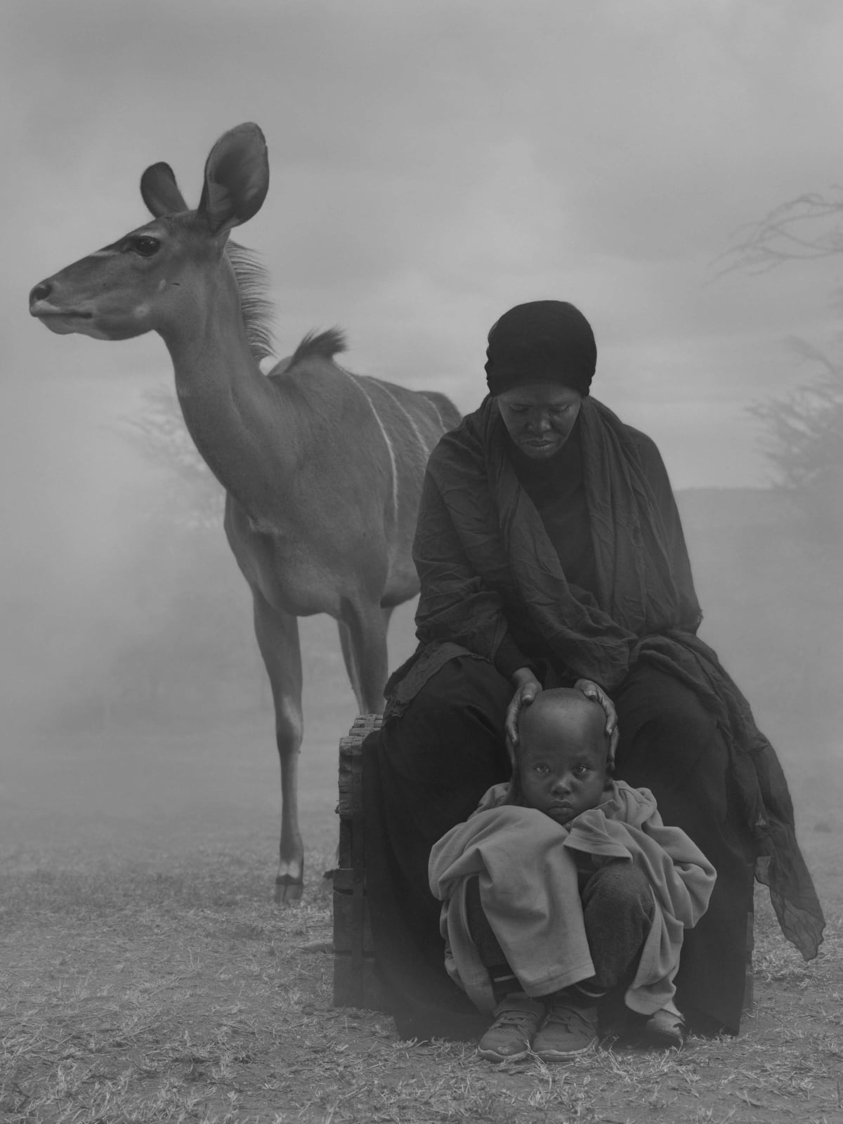 Gazelle and two women Halima, Abdul and Frida, Kenya by Nick Brandt