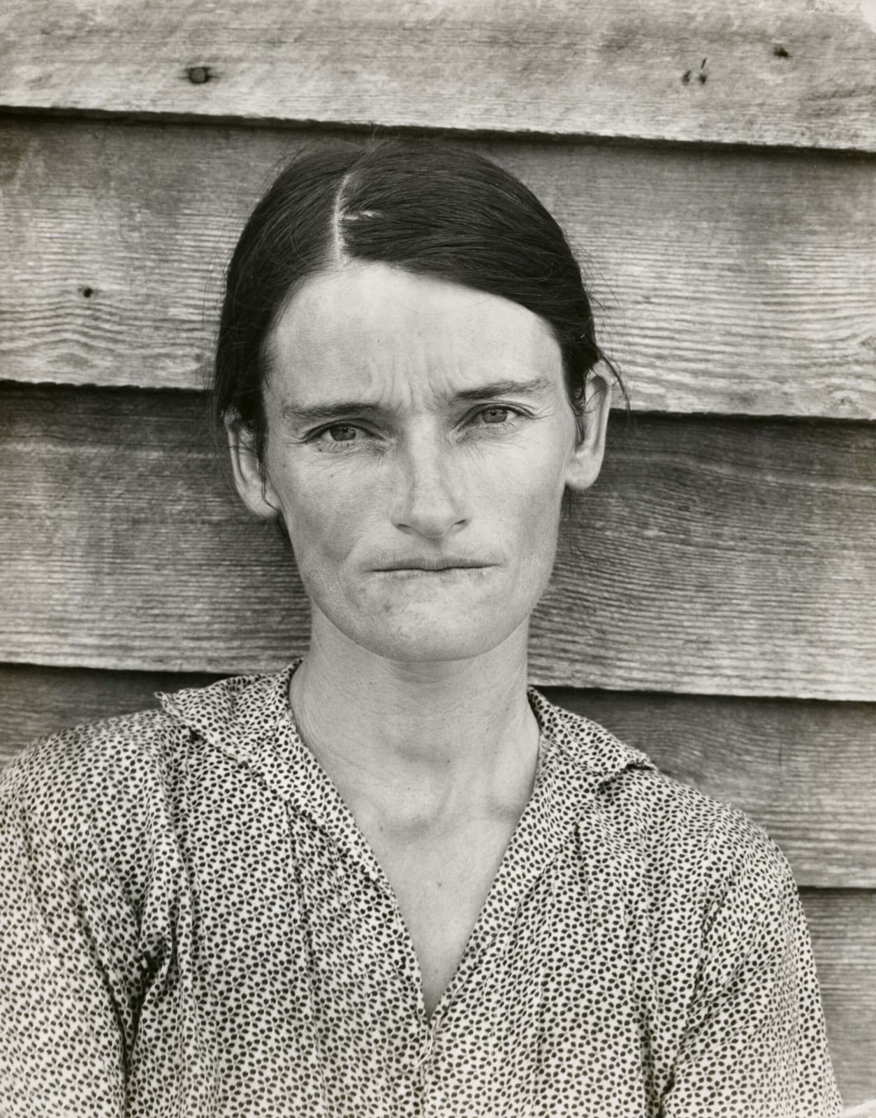 Walker Evans Allie Mae Burroughs Wife of Share Cropper portrait of woman in patterned shirt in front of wood shingles