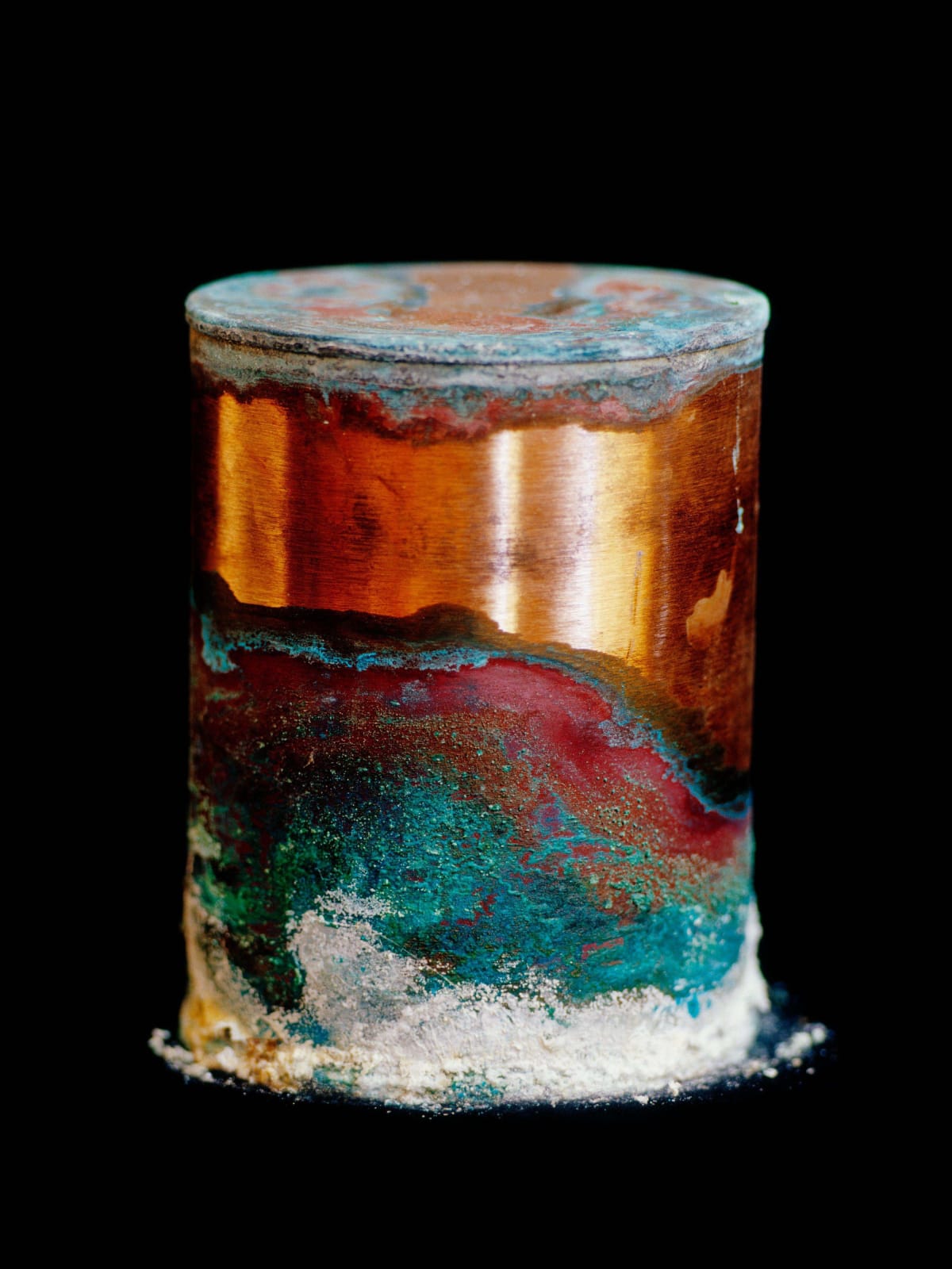 colorful minerals on copper canister, by David Maisel