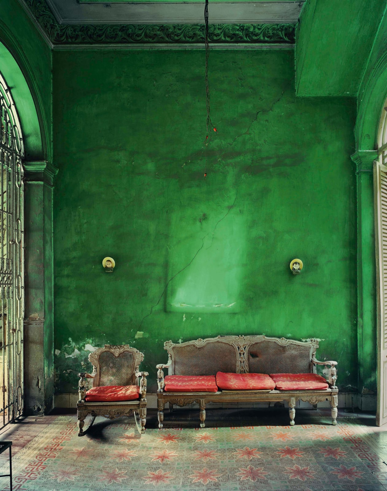 Michael Eastman photograph of green interior with red couch cushions in Havana, Cuba