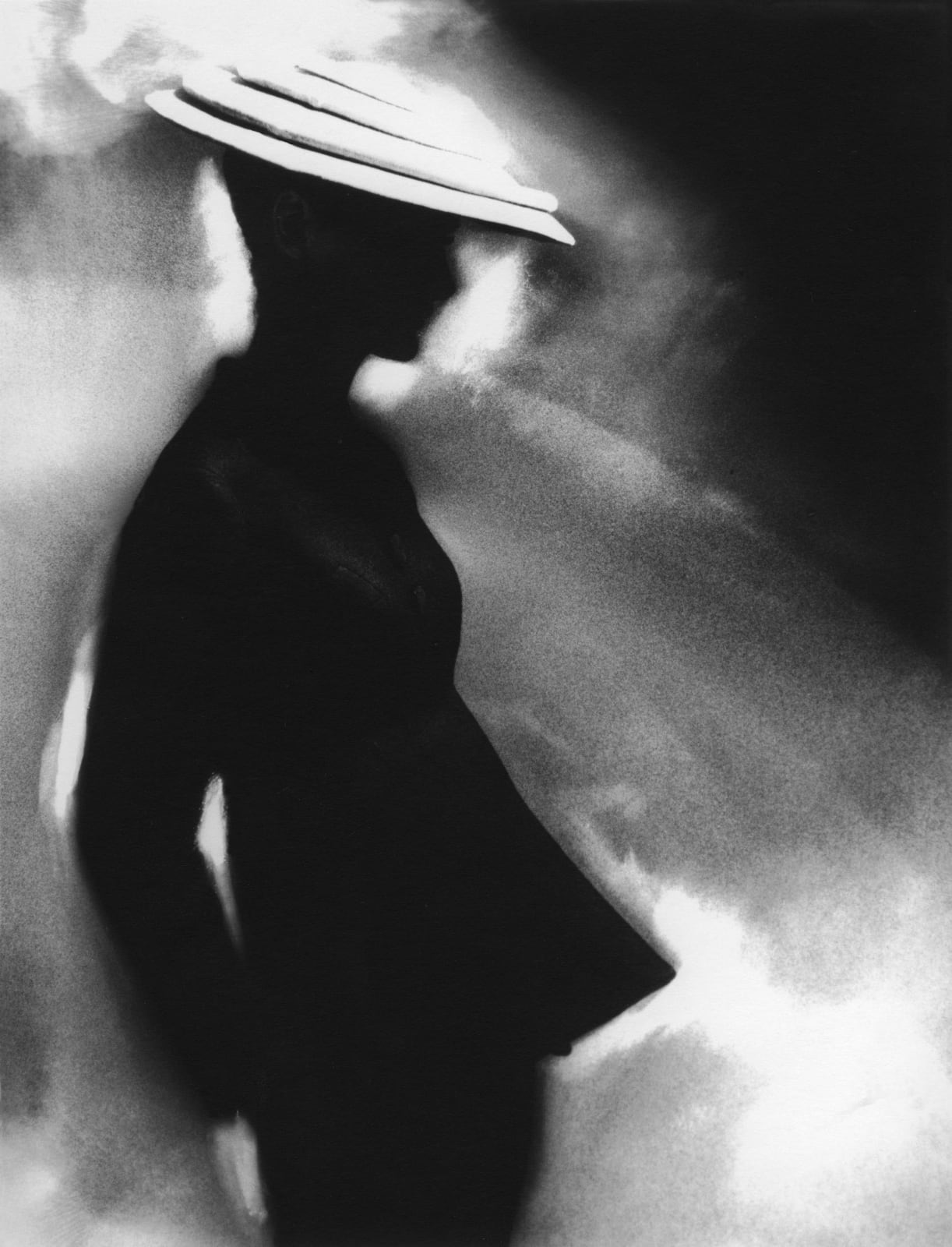 Lillian Bassman photograph of silhouetted woman in tunit suit and hat