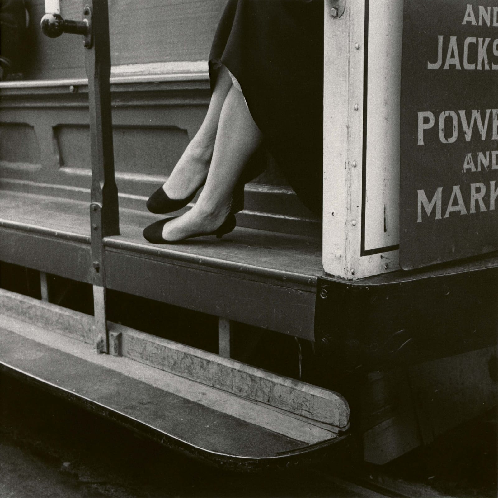 Dorothea Lange Cable Car San Francisco close up cropped image of woman's legs crossed while seated on cable car